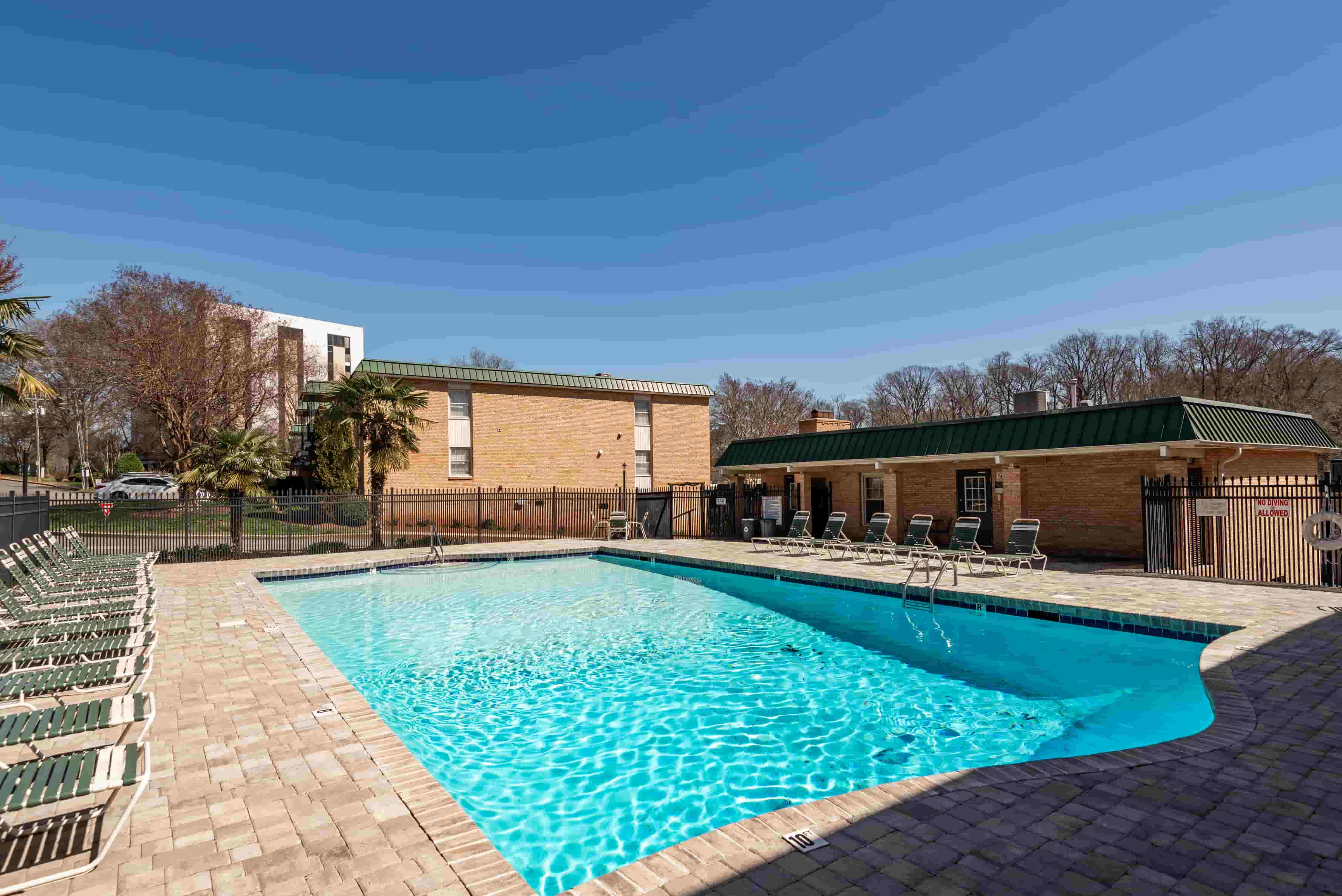 Franciscan Terrace pool deck with lounge chairs and afternoon sun